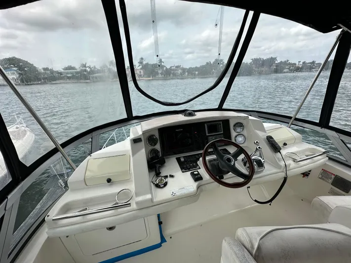  Yacht Photos Pics 2009 Sea Ray 36 Sedan Bridge helm with steering wheel, controls, and waterfront view.