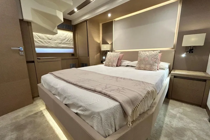  Yacht Photos Pics Luxurious bedroom interior of 2017 Prestige 680 yacht with elegant decor and ambient lighting.