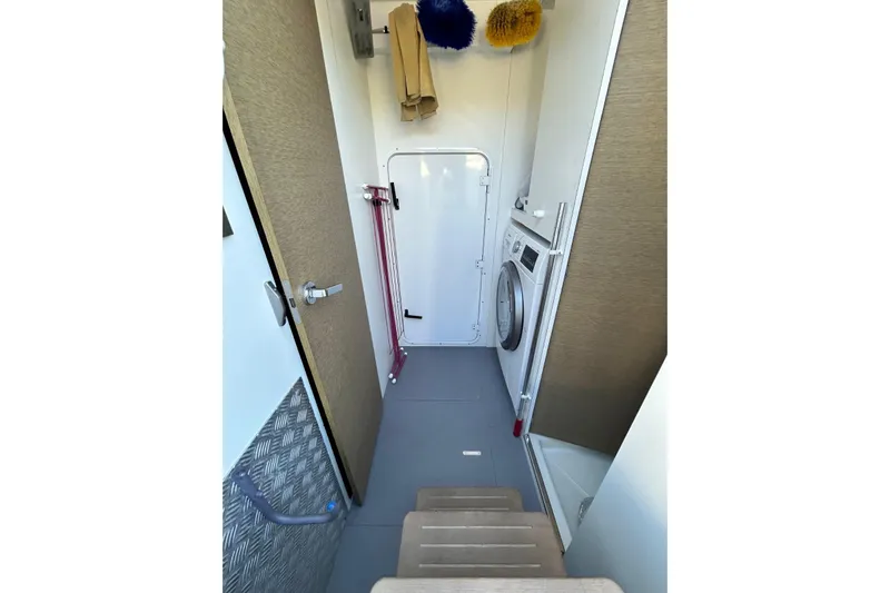  Yacht Photos Pics Laundry area in 2017 Prestige 680 yacht with washing machine and storage space.
