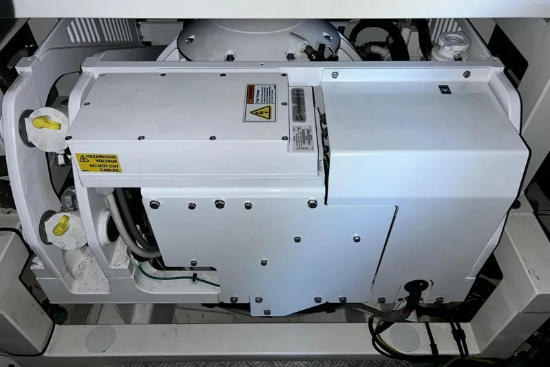  Yacht Photos Pics Engine compartment of a 2017 Prestige 680 yacht, featuring electrical components and warning labels.