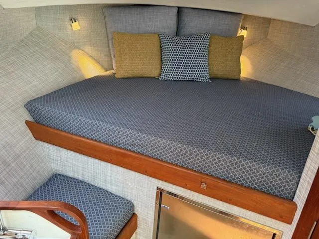 Outcast Yacht Photos Pics Cozy cabin interior of 2004 Mabry 40 boat with patterned bedding and cushions.