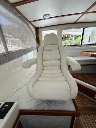 Outcast Yacht Photos Pics Luxurious white captain's chair in a 2004 Mabry 40 boat interior.