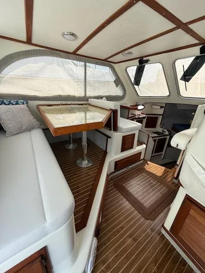 Outcast Yacht Photos Pics Interior of a 2004 Mabry 40 boat with wooden accents and seating area.
