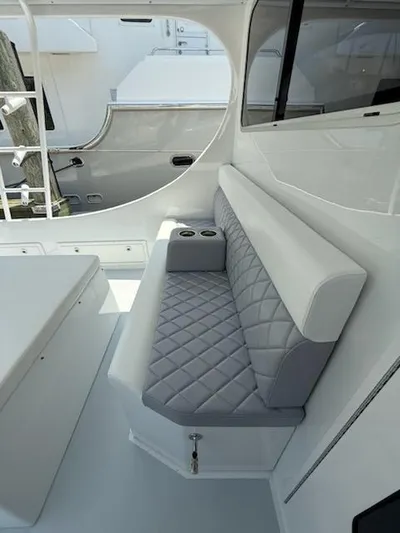 Outcast Yacht Photos Pics Luxurious seating area on a 2004 Mabry 40 boat with quilted upholstery and cup holders.