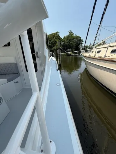 Outcast Yacht Photos Pics 2004 Mabry 40 boat docked beside another vessel on calm water.