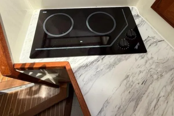 Outcast Yacht Photos Pics Marble countertop with electric cooktop in a 2004 Mabry 40 kitchen.