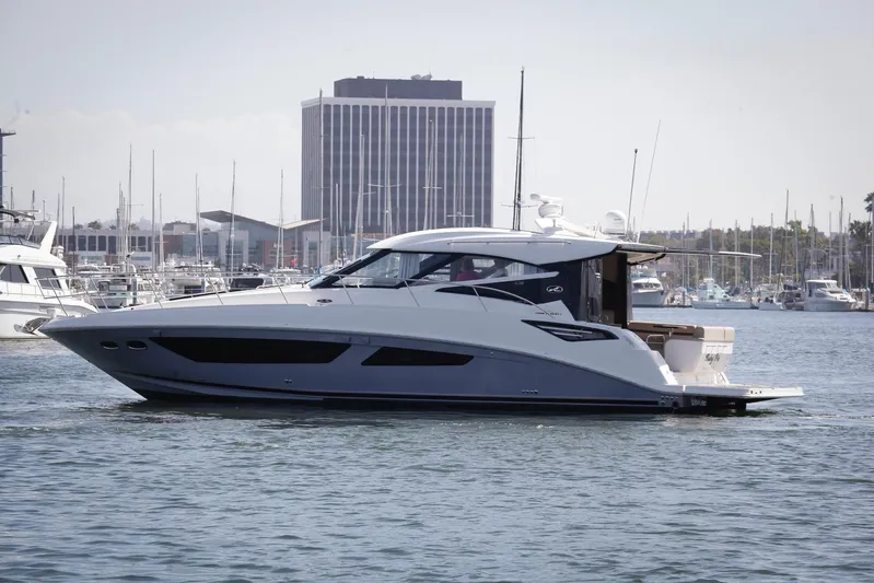 Baby Pie Yacht Photos Pics 2016 Sea Ray 470 Sundancer yacht docked in a marina with cityscape background.