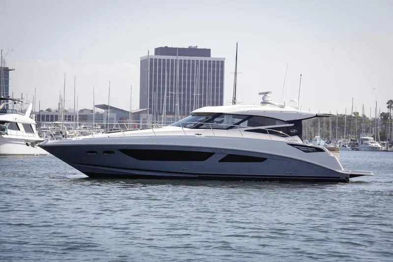 Baby Pie Yacht Photos Pics 2016 Sea Ray 470 Sundancer yacht cruising in a marina with cityscape backdrop.
