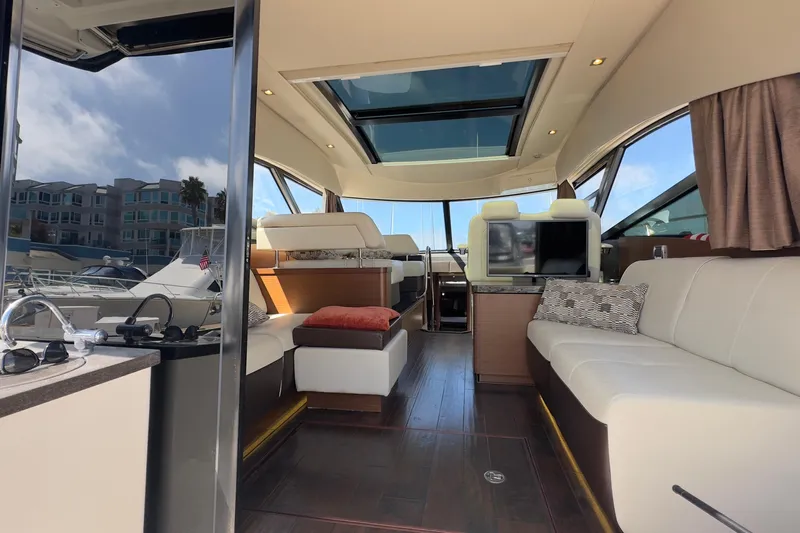 Baby Pie Yacht Photos Pics Luxurious interior of 2016 Sea Ray 470 Sundancer yacht with modern seating and skylight.