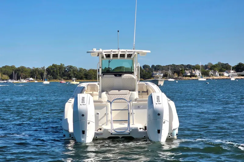  Yacht Photos Pics 2024 World Cat 325 CC boat on water, featuring dual outboard engines.