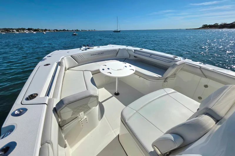  Yacht Photos Pics 2024 World Cat 325 CC boat interior with seating and table on calm water.