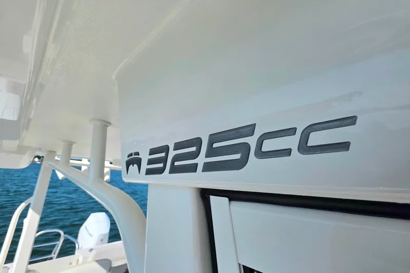  Yacht Photos Pics 2024 World Cat 325 CC boat logo on white surface, with ocean background.