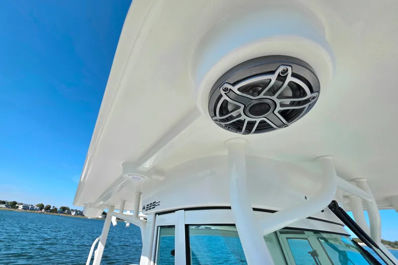  Yacht Photos Pics 2024 World Cat 325 CC boat with speaker on deck, blue sky background.