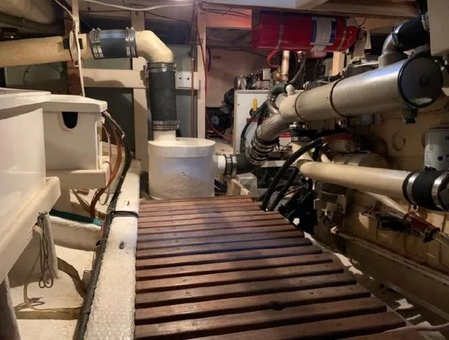  Yacht Photos Pics Engine room of 1990 Grand Banks 36 Europa yacht with visible pipes and equipment.