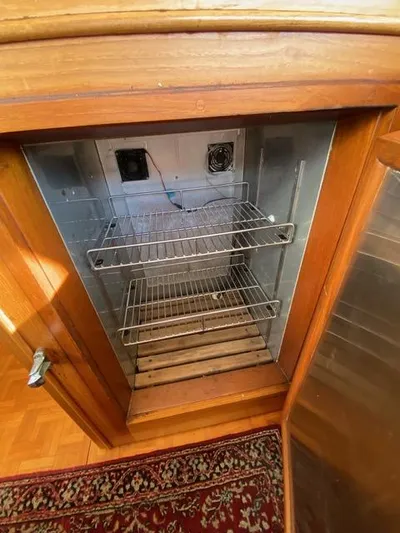  Yacht Photos Pics Empty metal shelving inside a wooden cabinet on a 1990 Grand Banks 36 Europa boat.