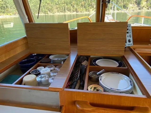  Yacht Photos Pics Interior of 1990 Grand Banks 36 Europa with organized kitchen storage and dishes.