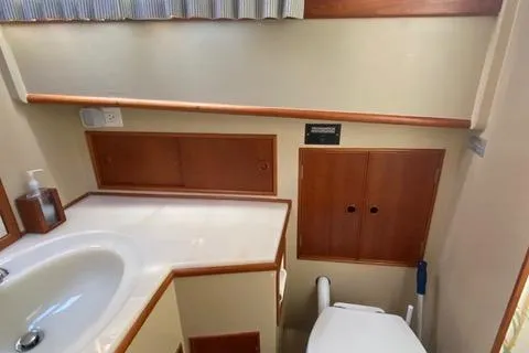  Yacht Photos Pics Bathroom interior of 1990 Grand Banks 36 Europa yacht, featuring sink and storage cabinets.