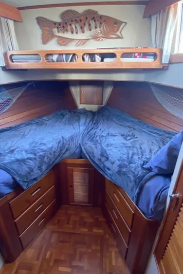  Yacht Photos Pics Cozy cabin interior of 1990 Grand Banks 36 Europa with wooden furnishings and nautical decor.