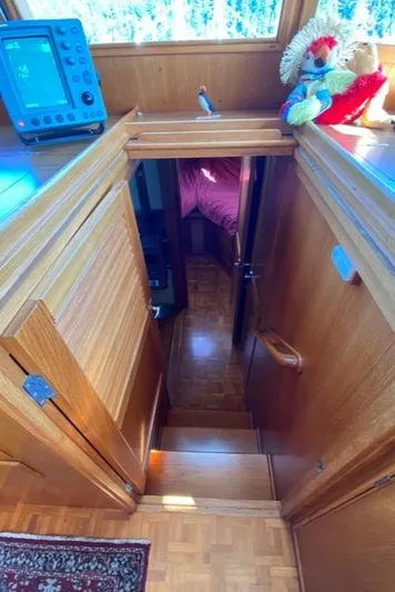  Yacht Photos Pics Interior of 1990 Grand Banks 36 Europa yacht with wooden stairs and nautical decor.