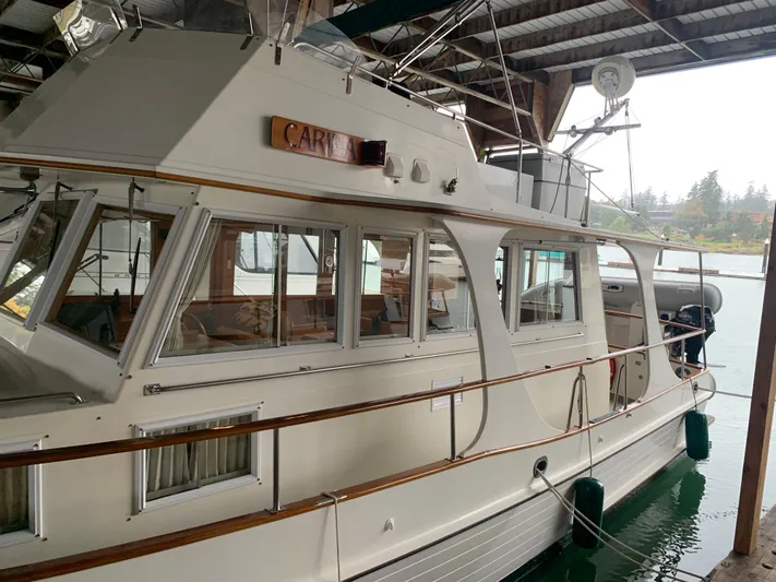  Yacht Photos Pics 1990 Grand Banks 36 Europa yacht docked under a covered marina.
