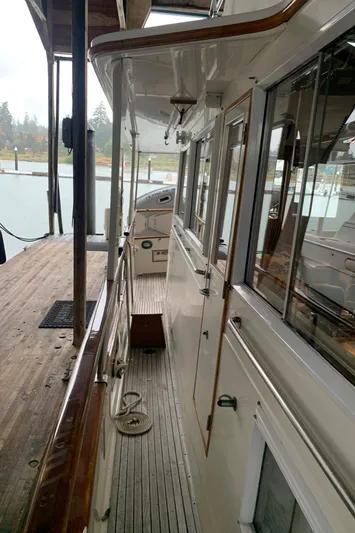  Yacht Photos Pics 1990 Grand Banks 36 Europa yacht docked, showcasing side deck and cabin windows.