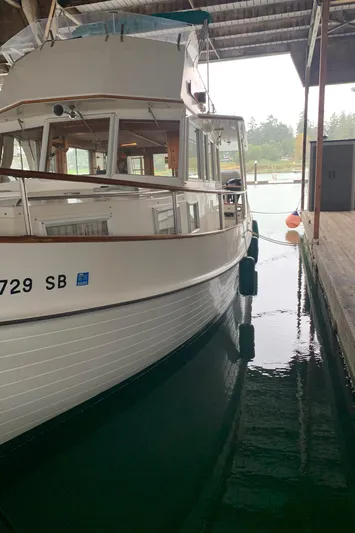  Yacht Photos Pics 1990 Grand Banks 36 Europa docked in a covered marina.
