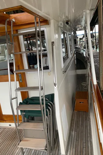  Yacht Photos Pics 1990 Grand Banks 36 Europa yacht deck with wooden accents and metal ladder.