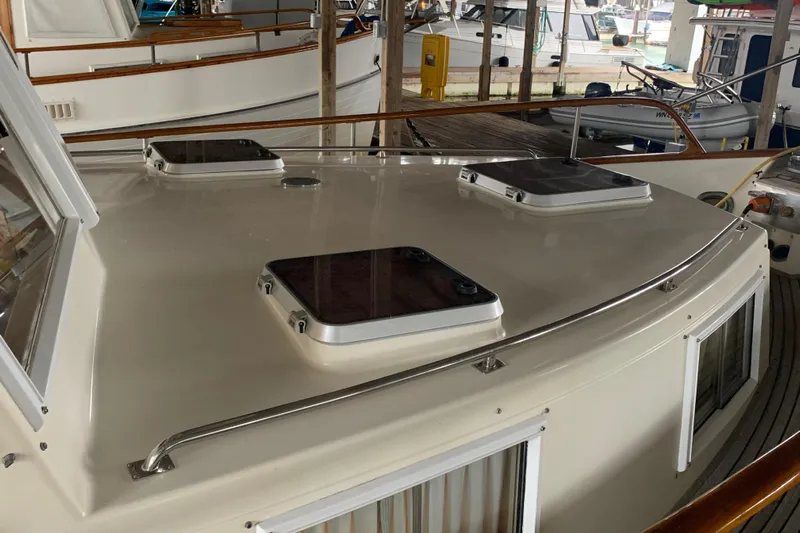  Yacht Photos Pics 1990 Grand Banks 36 Europa yacht deck with hatches in a marina.