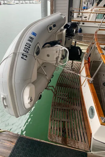  Yacht Photos Pics 1990 Grand Banks 36 Europa with dinghy on davits, docked in marina.