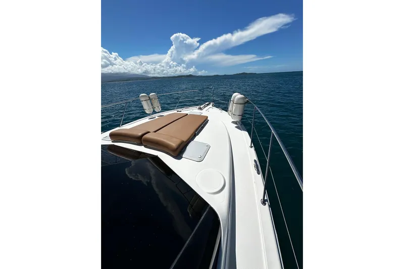  Yacht Photos Pics 2012 Riviera 43 Flybridge yacht deck with sun loungers on open sea.