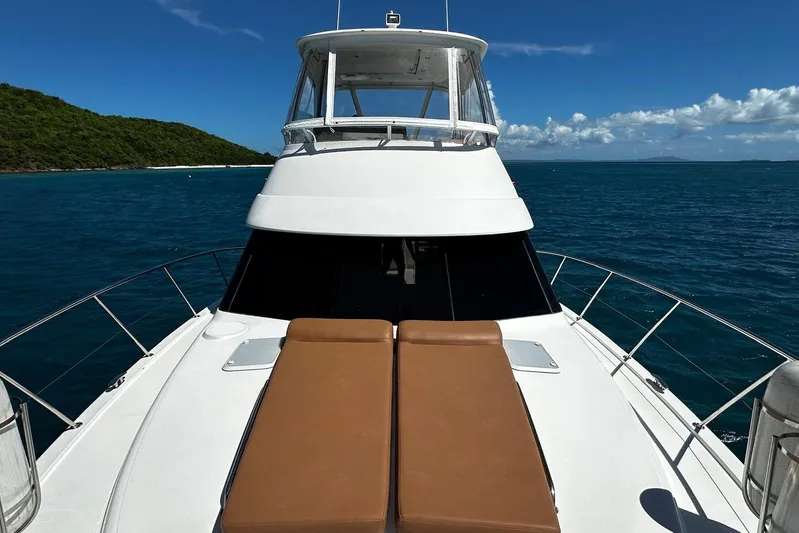  Yacht Photos Pics 2012 Riviera 43 Flybridge yacht on open sea with clear skies and lush coastline.