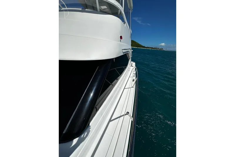  Yacht Photos Pics 2012 Riviera 43 Flybridge yacht cruising on clear blue waters.