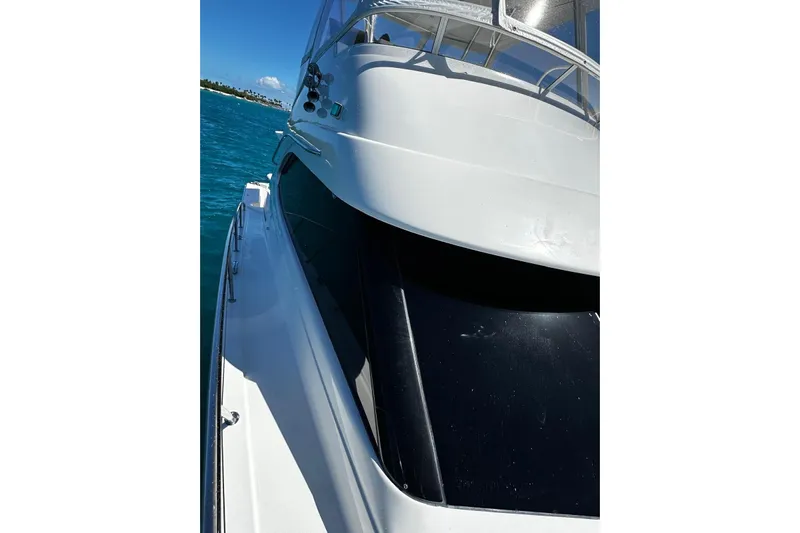  Yacht Photos Pics 2012 Riviera 43 Flybridge yacht on blue water, showcasing sleek design and modern features.