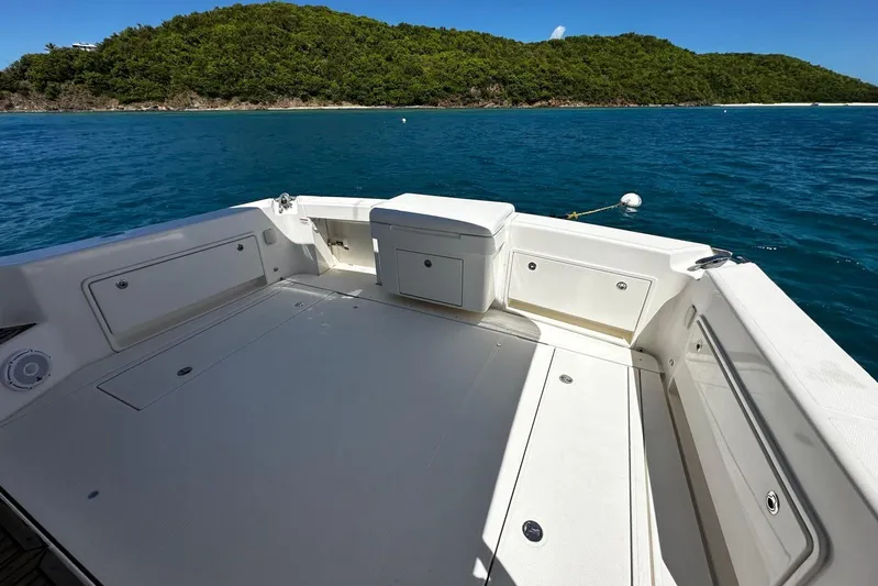  Yacht Photos Pics 2012 Riviera 43 Flybridge yacht deck with ocean view and lush green island backdrop.