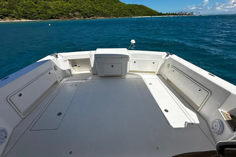 Yacht Photos Pics 2012 Riviera 43 Flybridge boat deck with ocean view and lush green island backdrop.