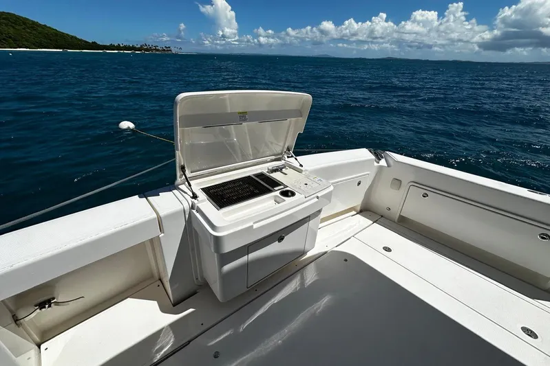  Yacht Photos Pics Riviera 43 Flybridge 2012 yacht deck with open grill, ocean view, and clear skies.