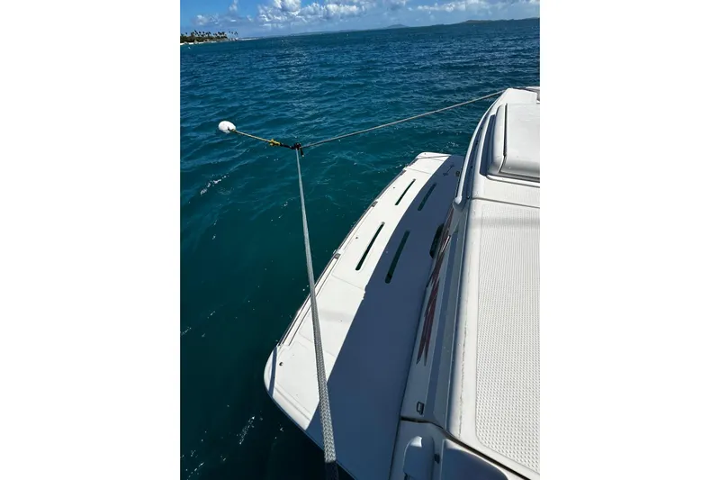  Yacht Photos Pics Riviera 43 Flybridge 2012 yacht on blue ocean water, sunny day, rear deck view.