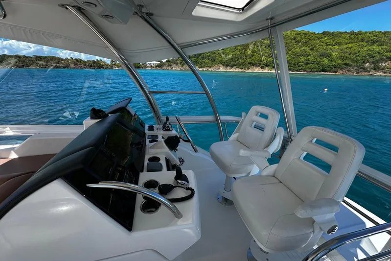  Yacht Photos Pics Flybridge of 2012 Riviera 43, featuring dual white captain chairs and scenic ocean view.