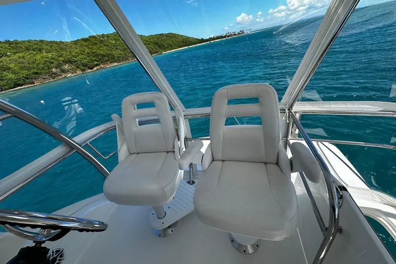  Yacht Photos Pics 2012 Riviera 43 Flybridge interior with ocean view and two white captain chairs.