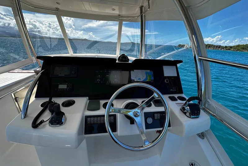  Yacht Photos Pics Cockpit view of 2012 Riviera 43 Flybridge yacht with ocean backdrop.