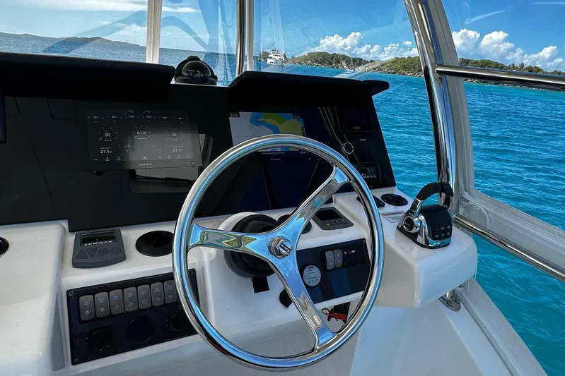  Yacht Photos Pics Cockpit view of 2012 Riviera 43 Flybridge yacht with steering wheel and navigation controls.
