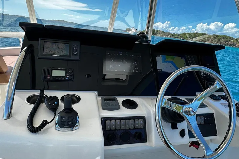  Yacht Photos Pics Helm of 2012 Riviera 43 Flybridge yacht with navigation equipment and steering wheel.