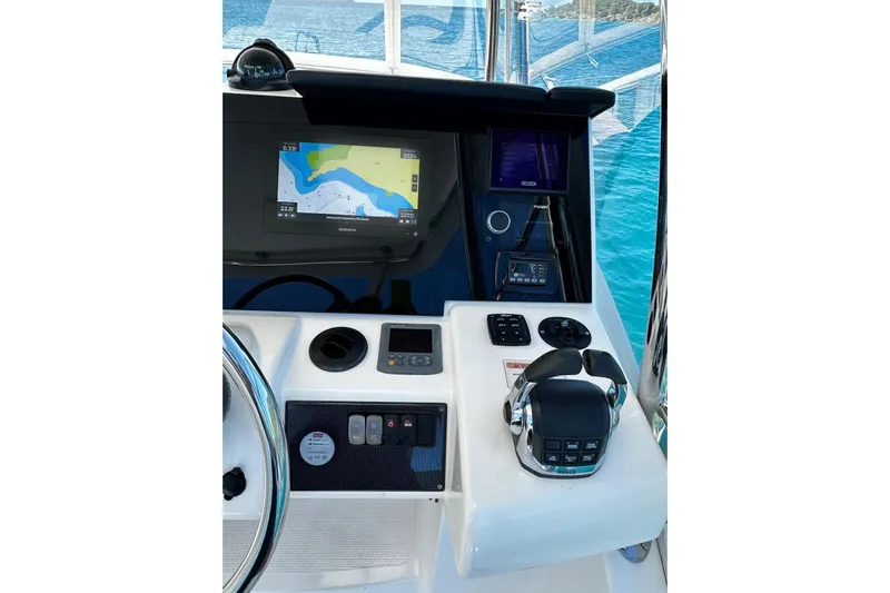  Yacht Photos Pics Control panel of 2012 Riviera 43 Flybridge yacht with navigation display and steering wheel.