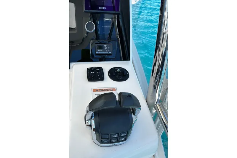  Yacht Photos Pics Control panel of 2012 Riviera 43 Flybridge yacht with throttle and navigation equipment.