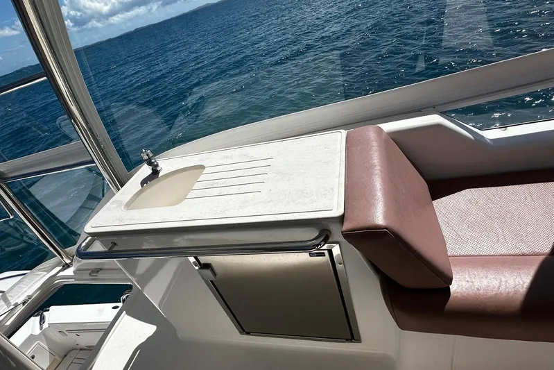  Yacht Photos Pics Riviera 43 Flybridge 2012 yacht interior with sink and seating, overlooking ocean.