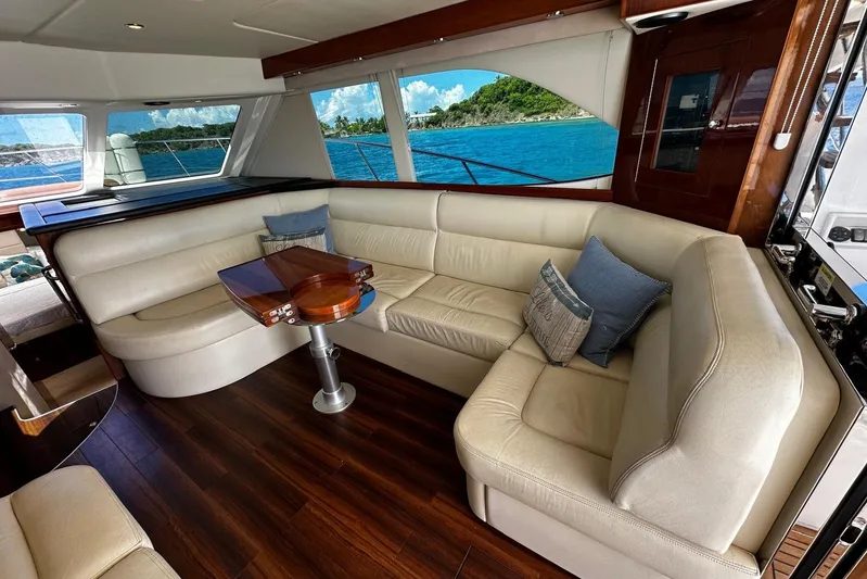  Yacht Photos Pics Luxurious interior of 2012 Riviera 43 Flybridge yacht with plush seating and ocean view.