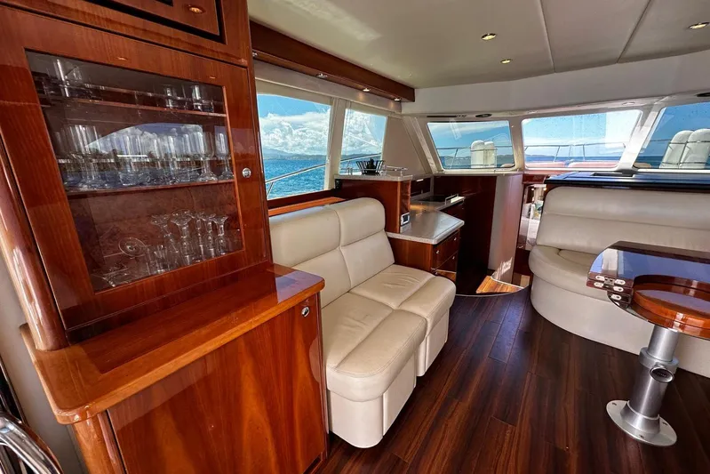 Yacht Photos Pics Luxurious interior of 2012 Riviera 43 Flybridge yacht with elegant wood finishes and plush seating.