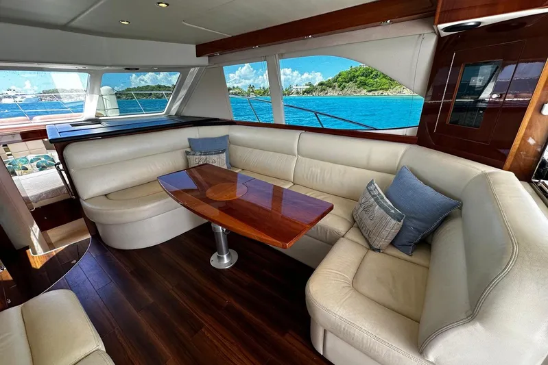  Yacht Photos Pics Luxurious interior of 2012 Riviera 43 Flybridge yacht with elegant seating and ocean view.