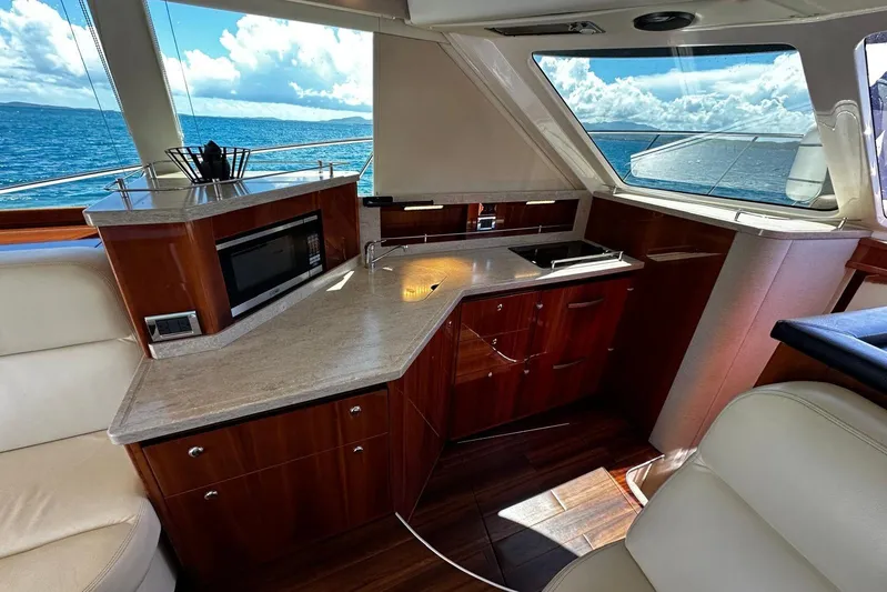  Yacht Photos Pics Luxurious interior of 2012 Riviera 43 Flybridge yacht with modern kitchen and ocean view.