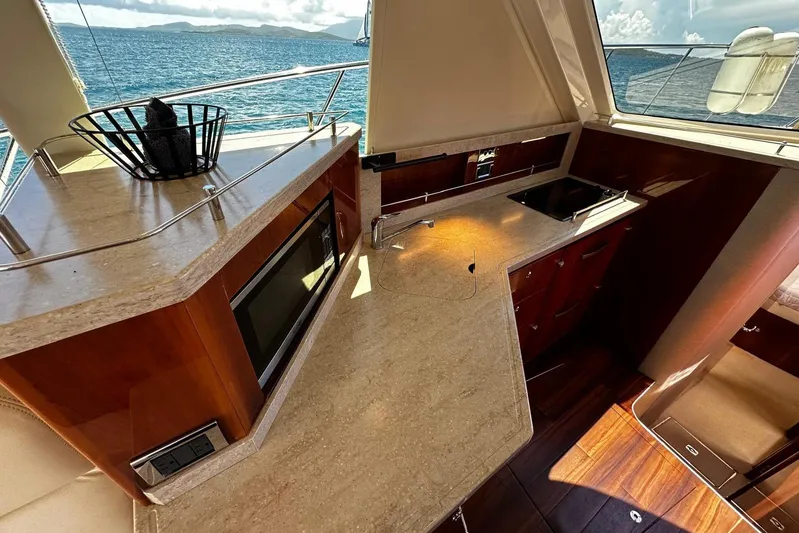  Yacht Photos Pics Luxurious 2012 Riviera 43 Flybridge yacht kitchen with modern amenities and ocean view.